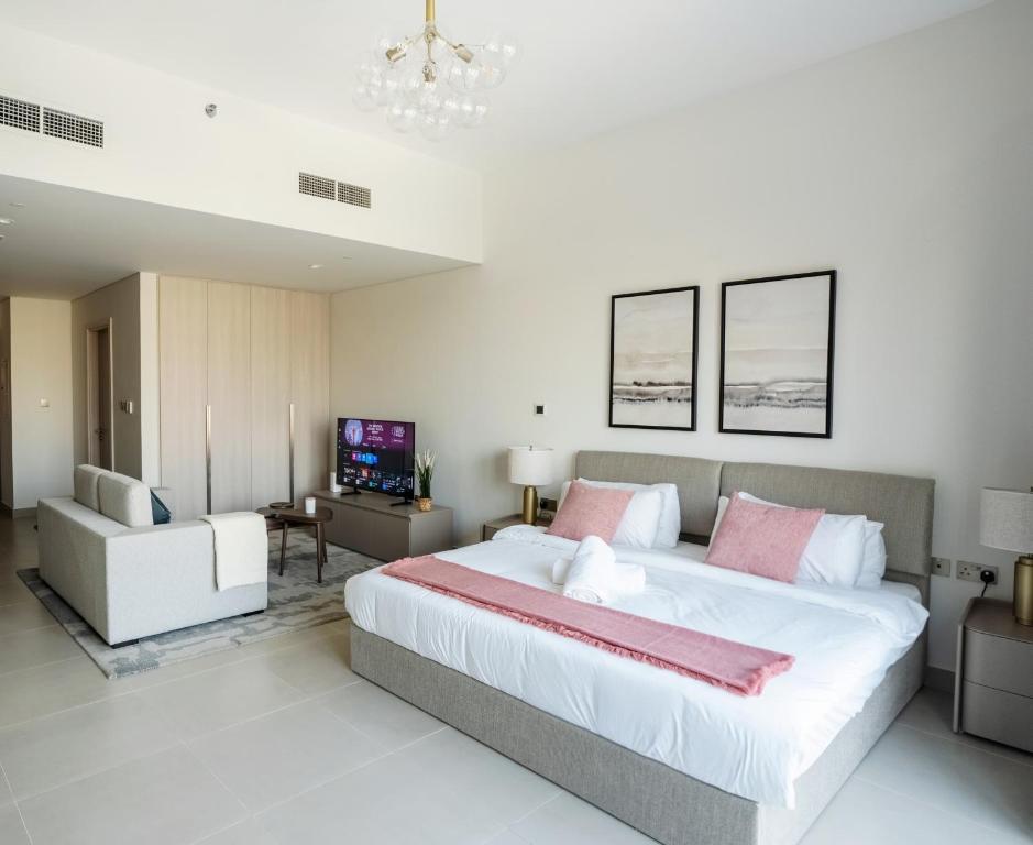 a large bedroom with a large bed and a television at Studio on Yas Island with Big Balcony, Near F1, Water Park and Ferrari view in Abu Dhabi