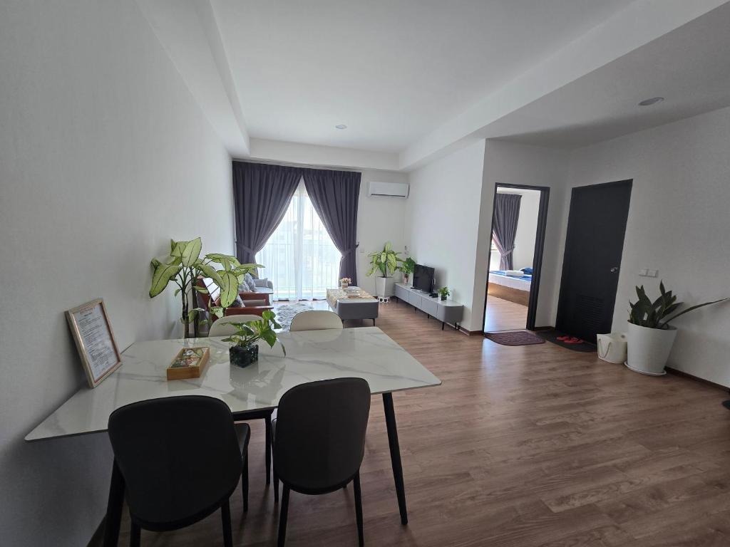 a living room with a white table and chairs at Jenz-2 Homestay in Bintulu