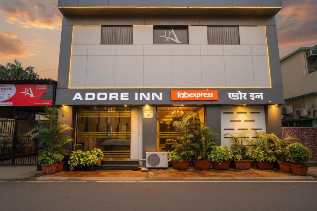 a store front with potted plants in front of it at FabExpress Adore Inn - Nr Mumbai International Airport in Mumbai