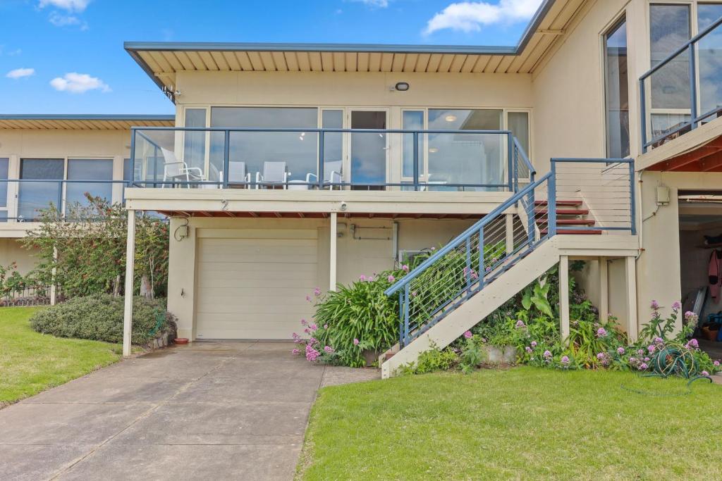 a house with a glass balcony and a driveway at Lovely Unit with Glorious Sea Views in McCracken
