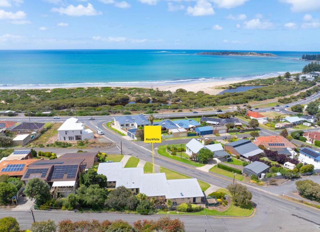 an aerial view of a suburb with the beach at Coastal Corner in McCracken