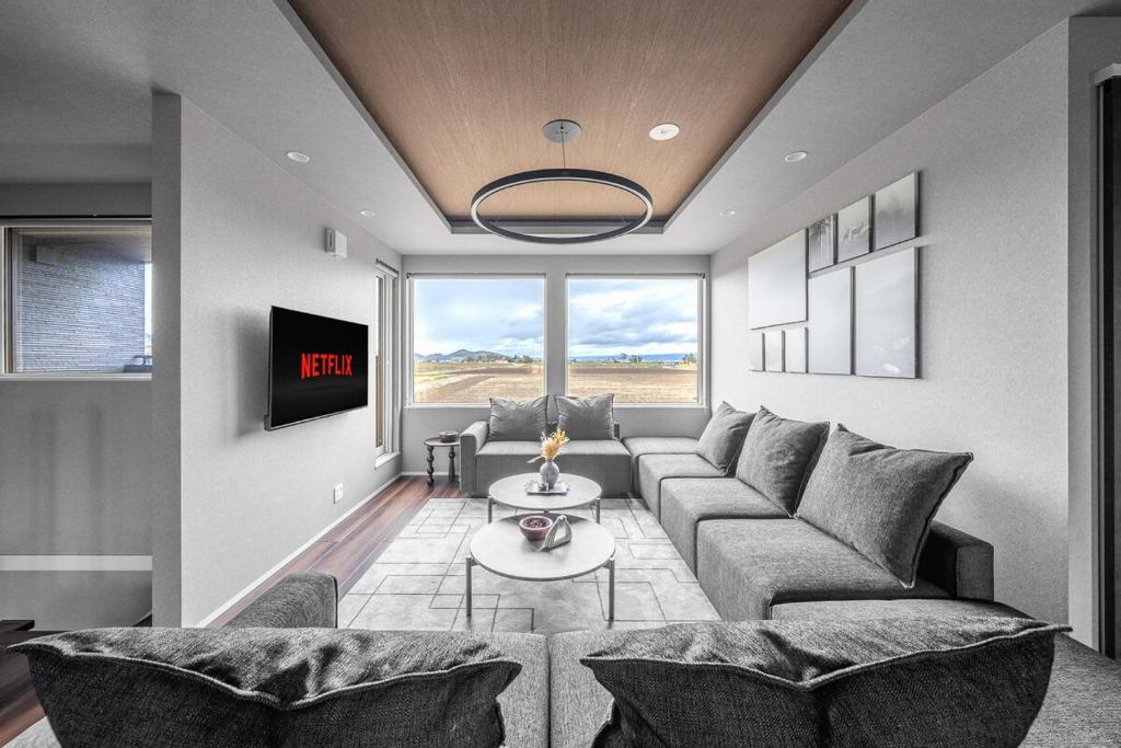 a living room with a couch and a table at Orvia Yig Villa in Furano