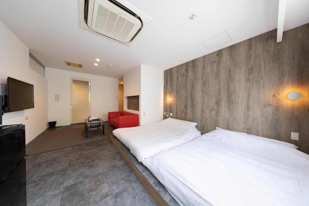 Ένα ή περισσότερα κρεβάτια σε δωμάτιο στο Huntelia Matsuyama