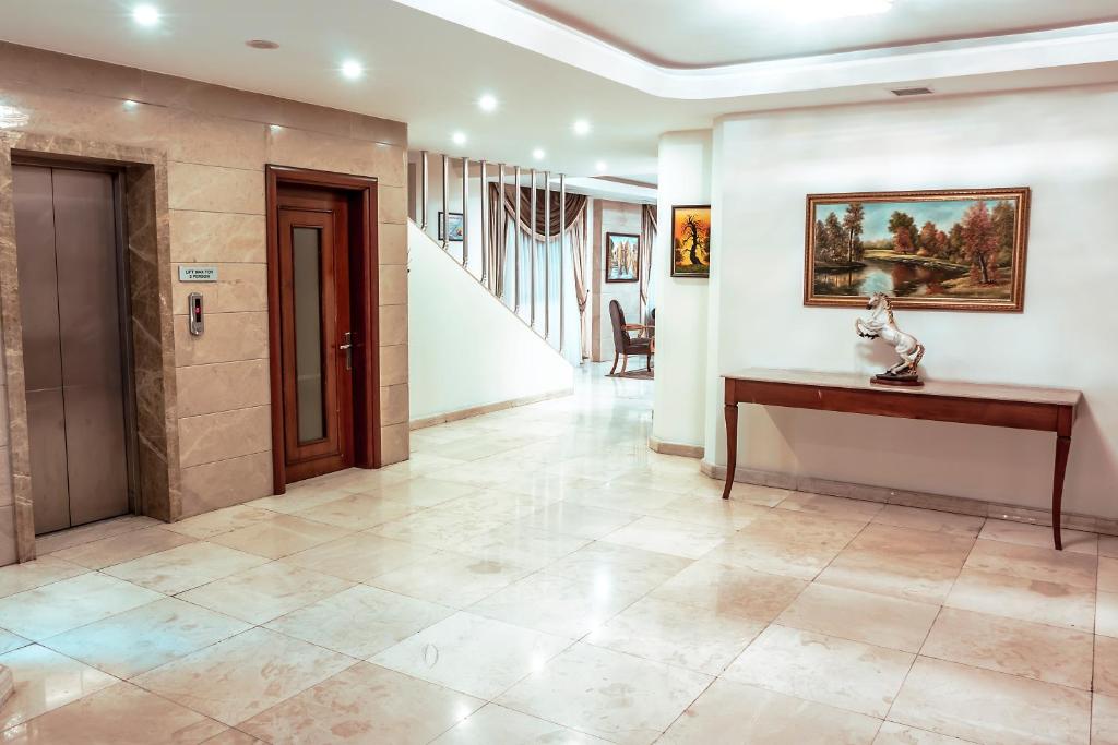 a hallway with a table and a staircase in a house at Atropat Old City Hotel in Baku