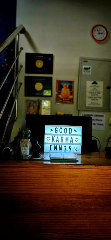 a sign that says good karma timbers on a desk at Goodkarma Inn in Cochin