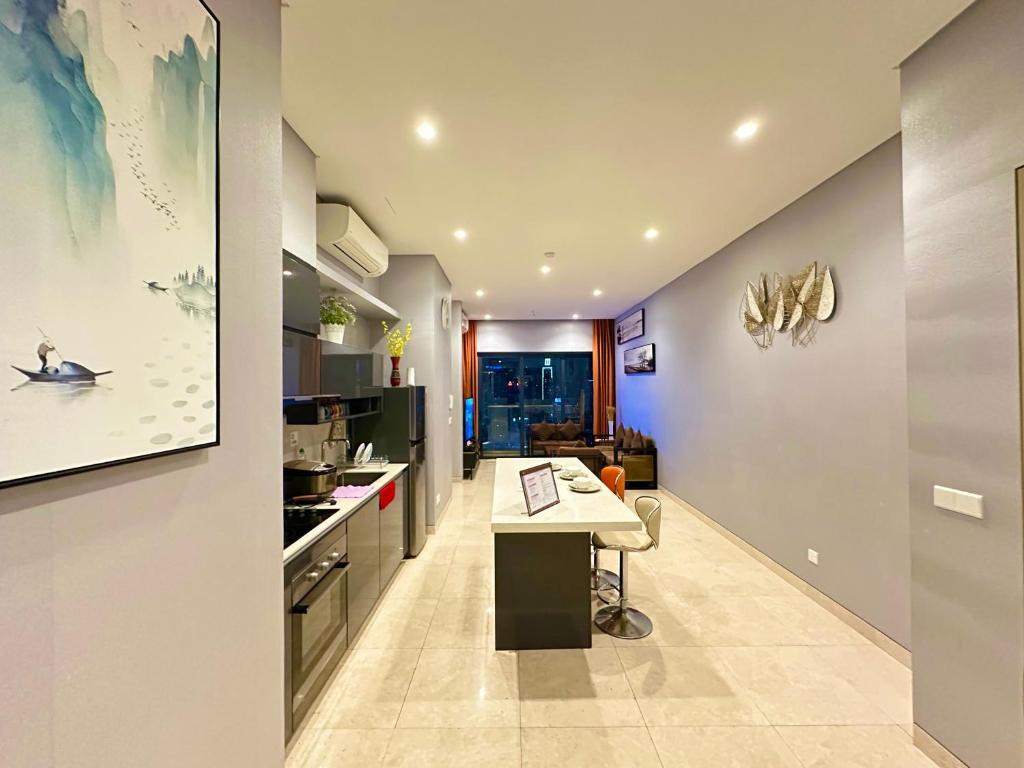 a kitchen with a island in the middle of a room at Lucentia Residence by Infinity swimming pool,lalaport KL in Kuala Lumpur
