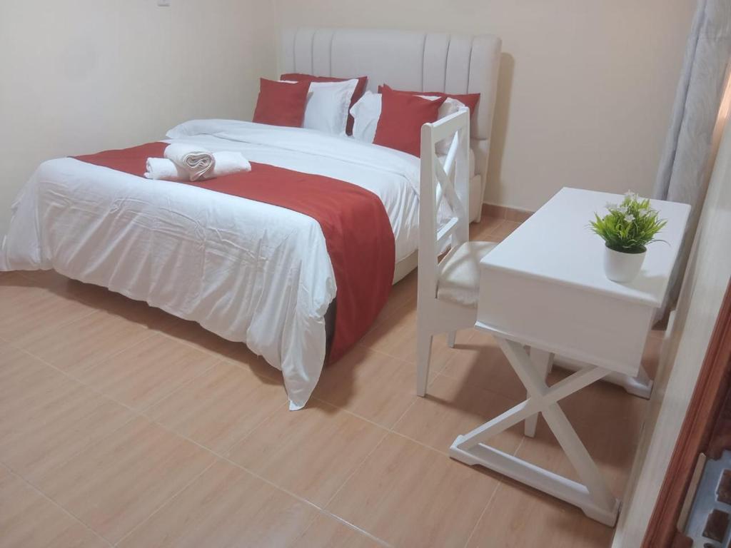 Ένα ή περισσότερα κρεβάτια σε δωμάτιο στο Oasis gardens Deliverance road