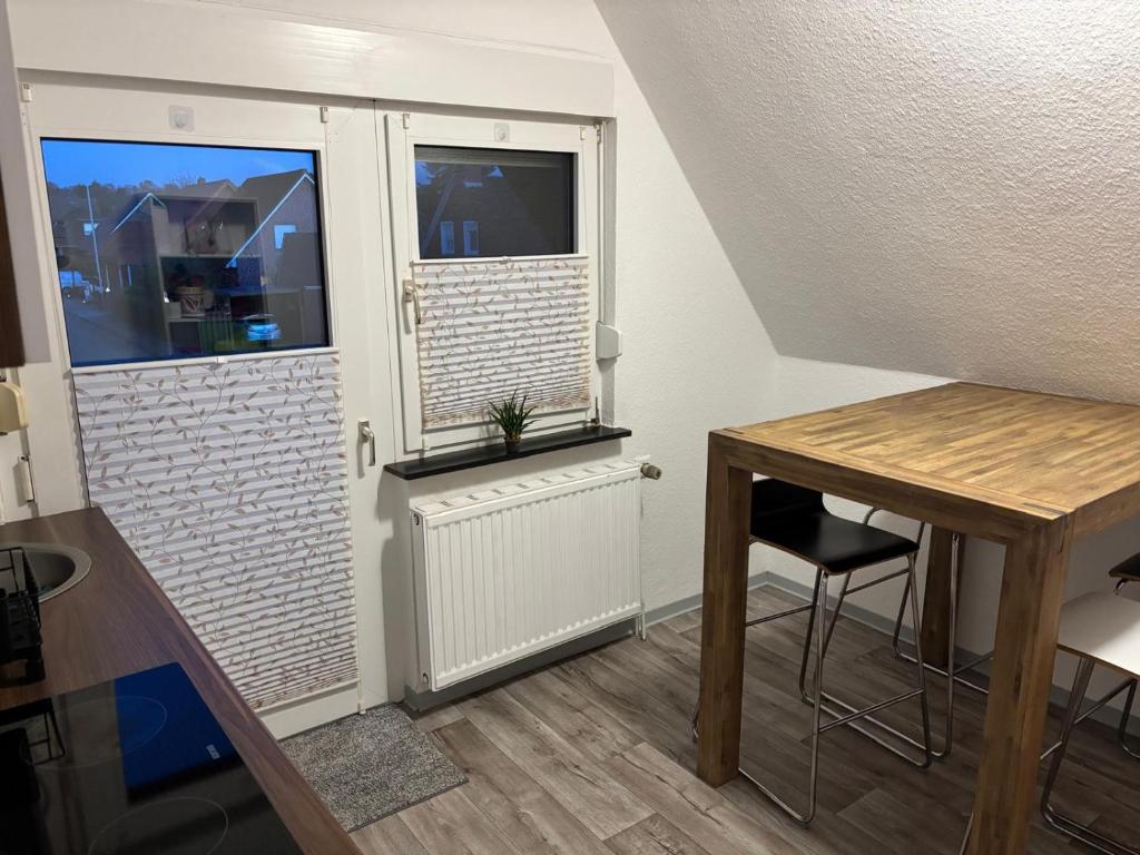 a small room with a table and a window at FeWo Papenburg im OG - Nähe City in Papenburg