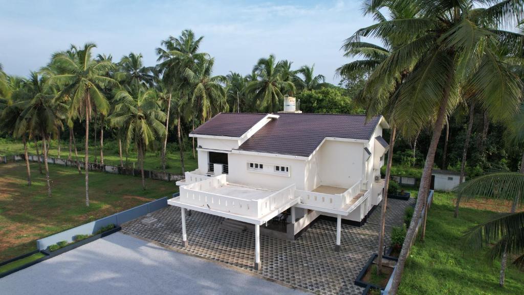 a house on a lot with palm trees at Prashanthi Nature View - Luxury 2Bhk Villa in Udupi