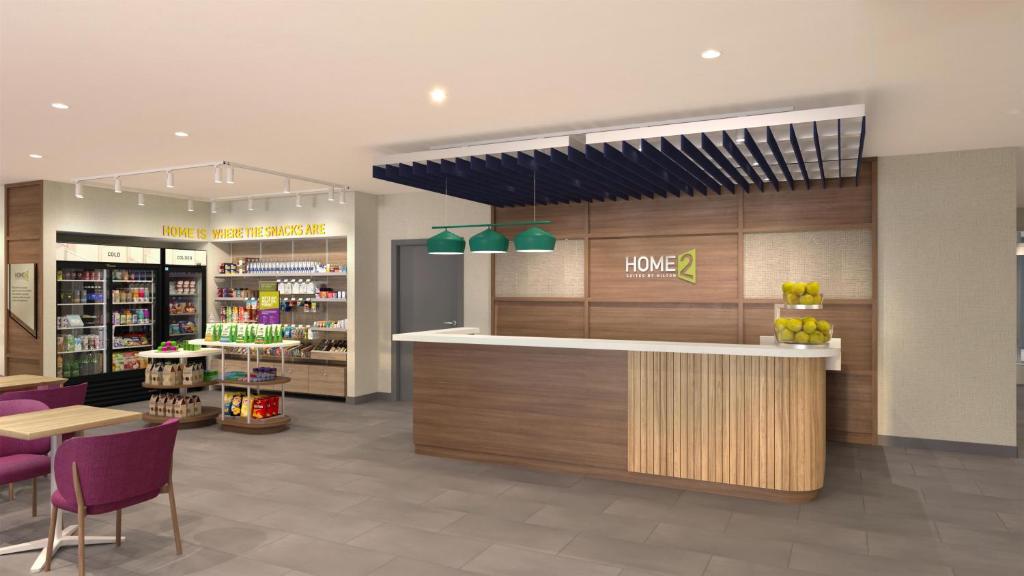 a store with a counter and chairs in a store at Home2 Suites By Hilton Kalamazoo Southeast in Kalamazoo