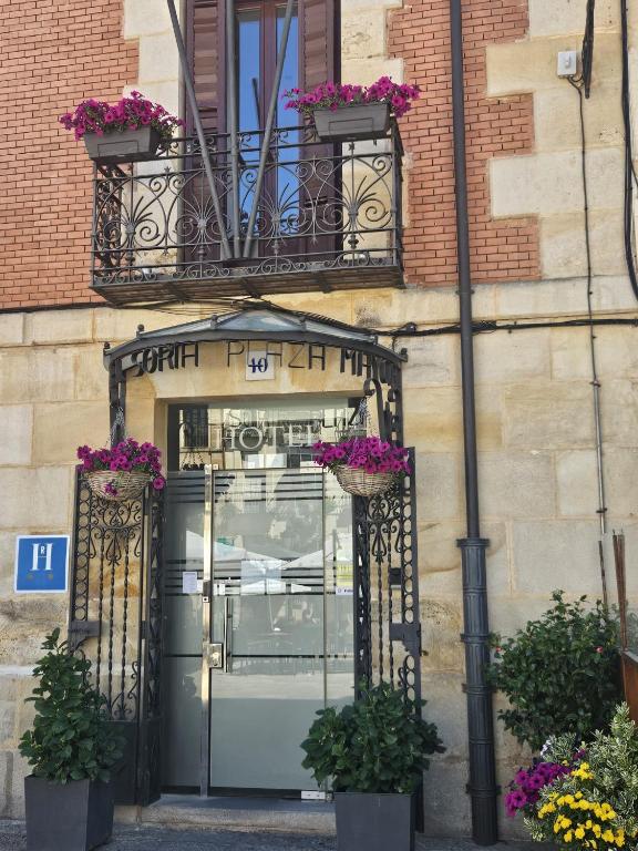 a front door of a building with flowers on it at Hotel Soria Plaza Mayor in Soria