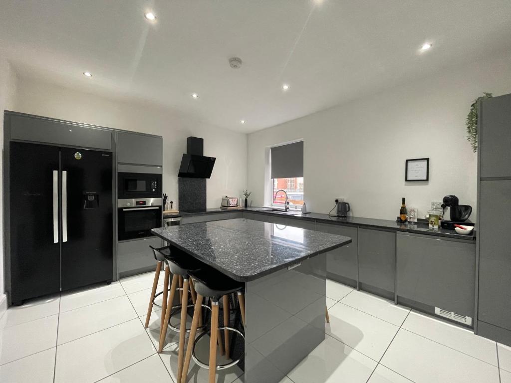 a kitchen with black appliances and a black counter top at Holdsworth House Apartments in Killingbeck