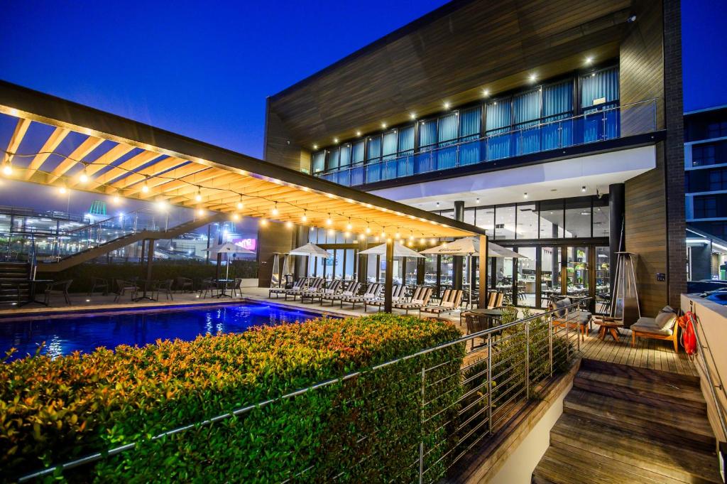 a building with a swimming pool in front of a building at The Capital Mbombela in Nelspruit