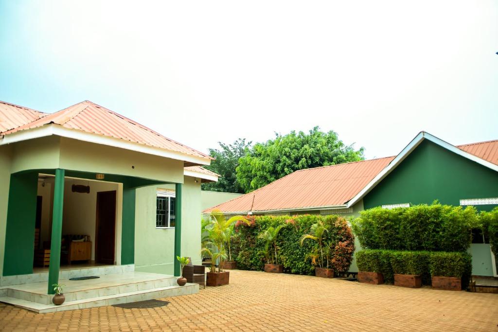 a green house with a red roof at Go Culture Africa in Entebbe