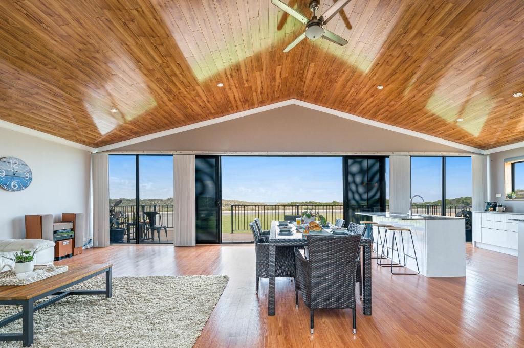 a dining room and living room with a ceiling fan at Ocean Moore - Uninterrupted Ocean Views in Guilderton