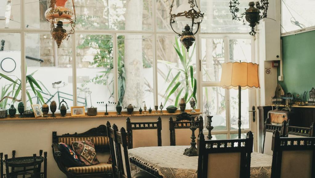 a dining room with a table and chairs and a window at Tzefania Hotel in Jerusalem