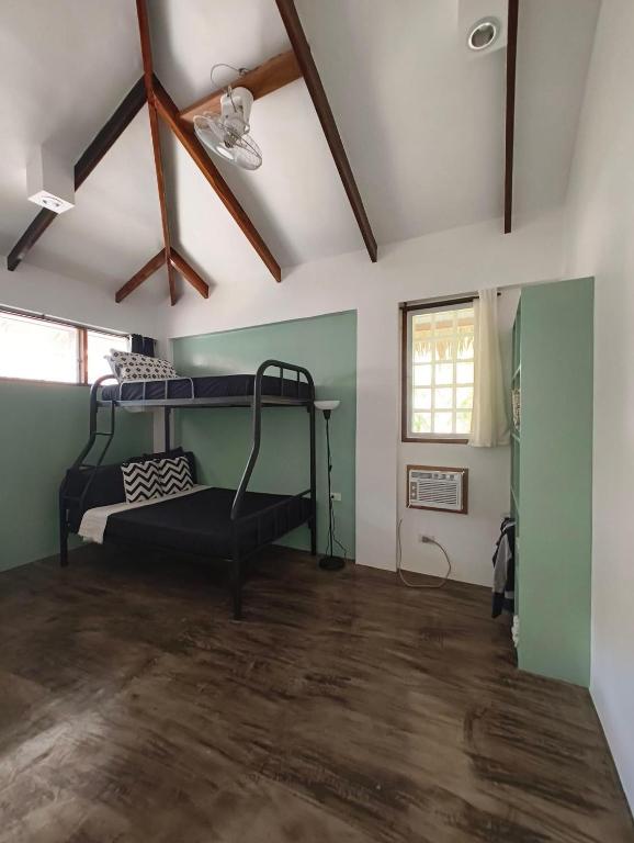 a room with a bunk bed in the ceiling at Casa del mar house in Paje