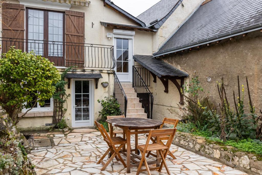 a patio with a table and chairs in front of a house at maison Amboise in Limeray