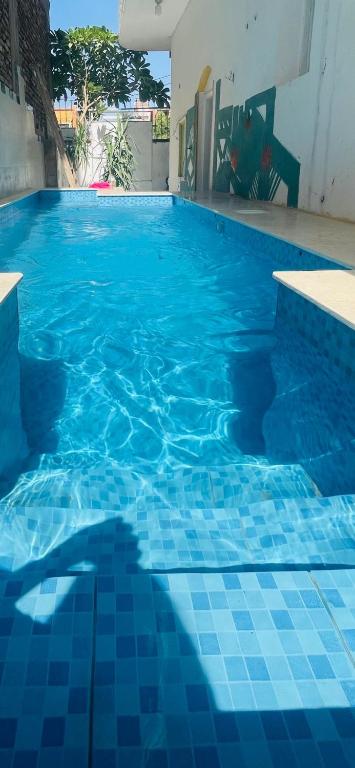 a blue tile swimming pool with a blue tile floor at Roses House Ladies & families only in Luxor