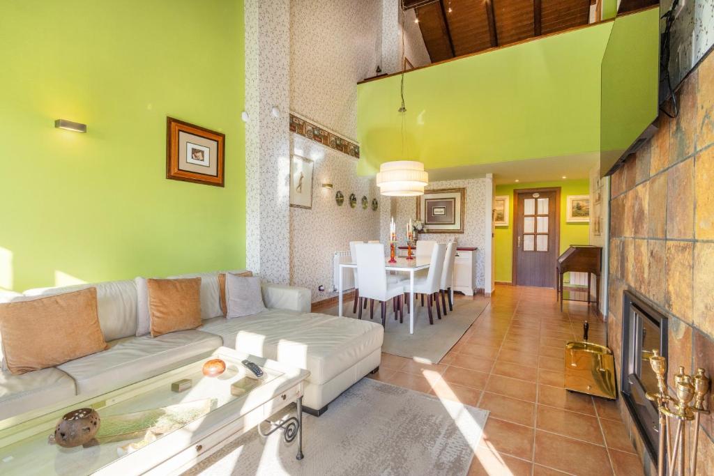 Una sala de estar con un sofá y un comedor. en Un duplex con encanto, en Jaca
