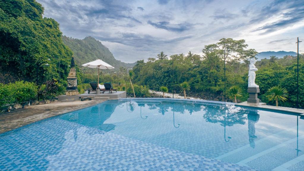 a swimming pool with a view of a mountain at The River Island Sidemen in Sidemen