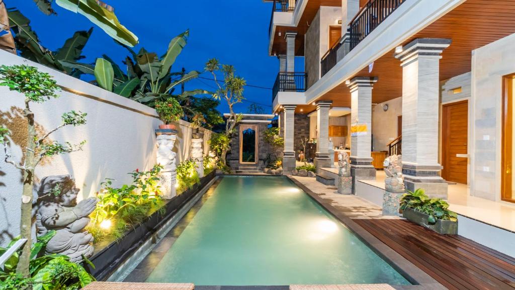 an infinity pool in the backyard of a house at Lavana Ubud in Ubud