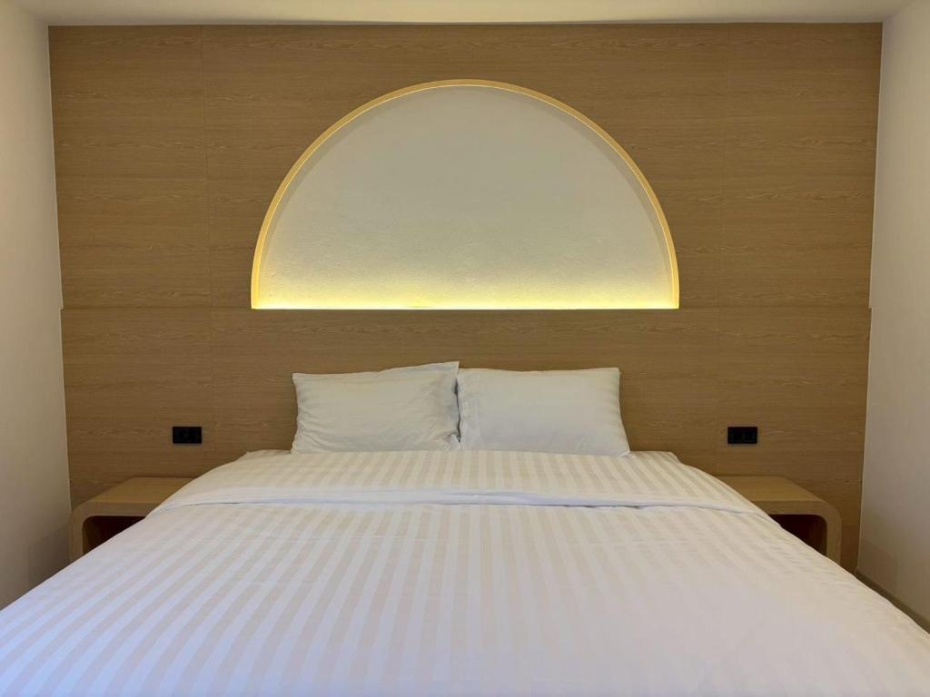 a bedroom with a large bed with an arch above it at Luna Resident in Ban Bang Phai
