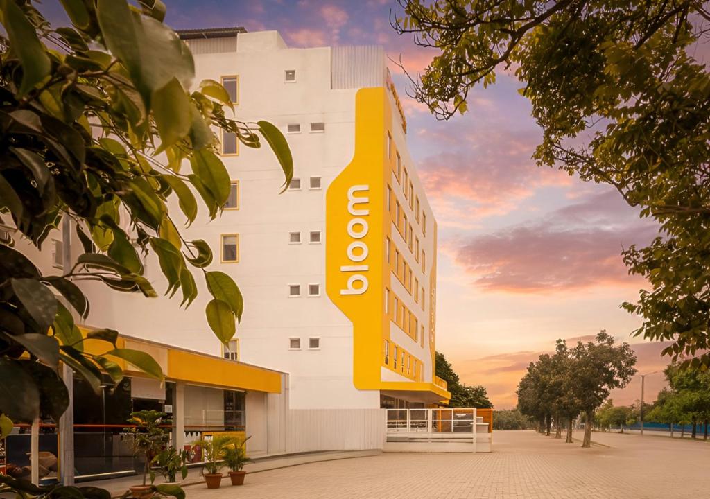 a building with a sign on the side of it at Bloom Hotel - Whitefield in Bangalore
