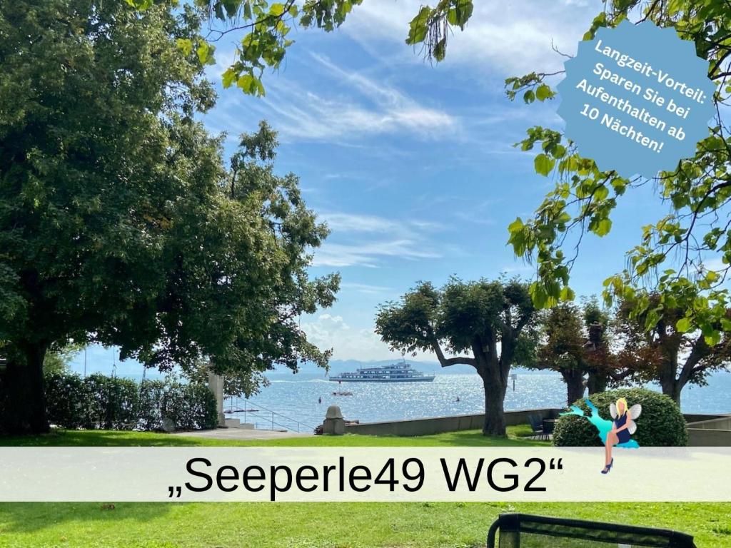 a girl jumping in the air in a park next to the water at Ferienwohnung Seeperle49 WG2 - Besonders, stilvoll mit eigenem Badestrand in Nonnenhorn