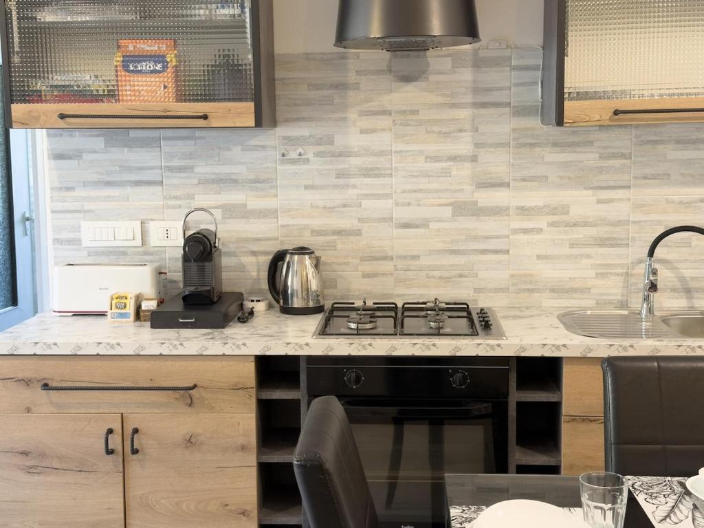 a kitchen with a stove and a counter top at Quiet Home in Val Brona in Valbrona