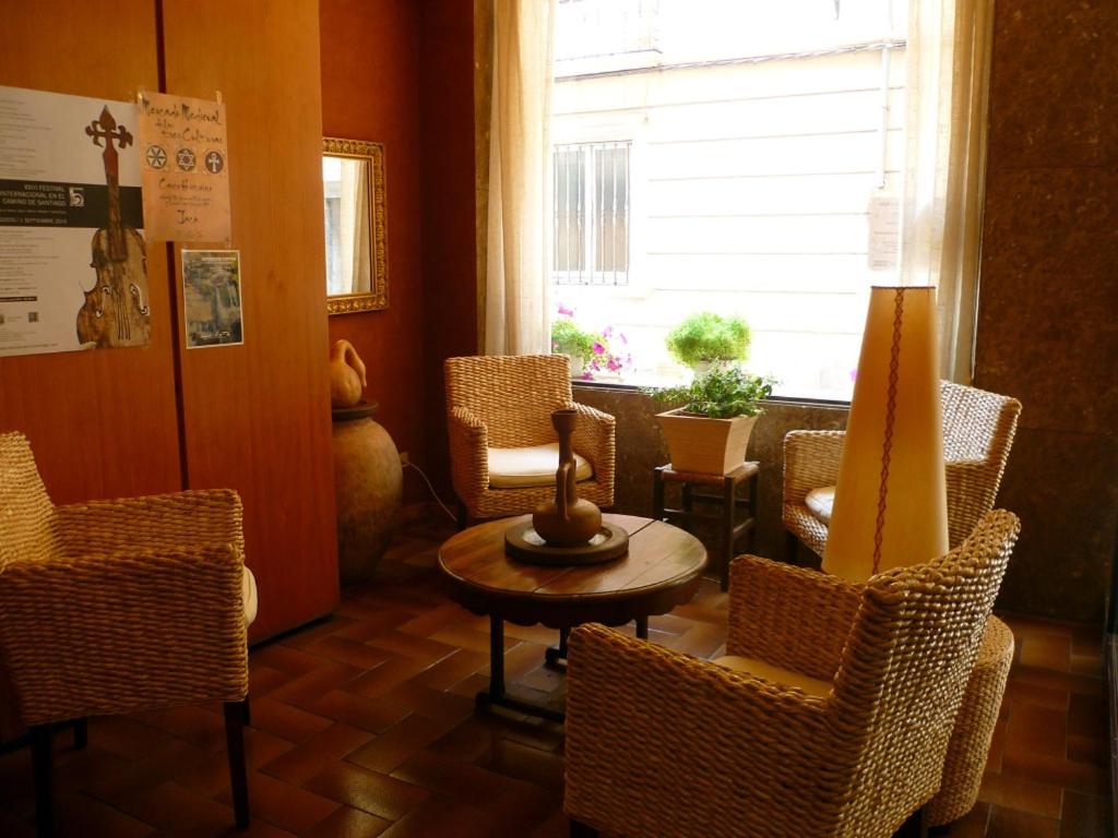 a room with chairs and a table and a window at Hotel Pradas in Jaca