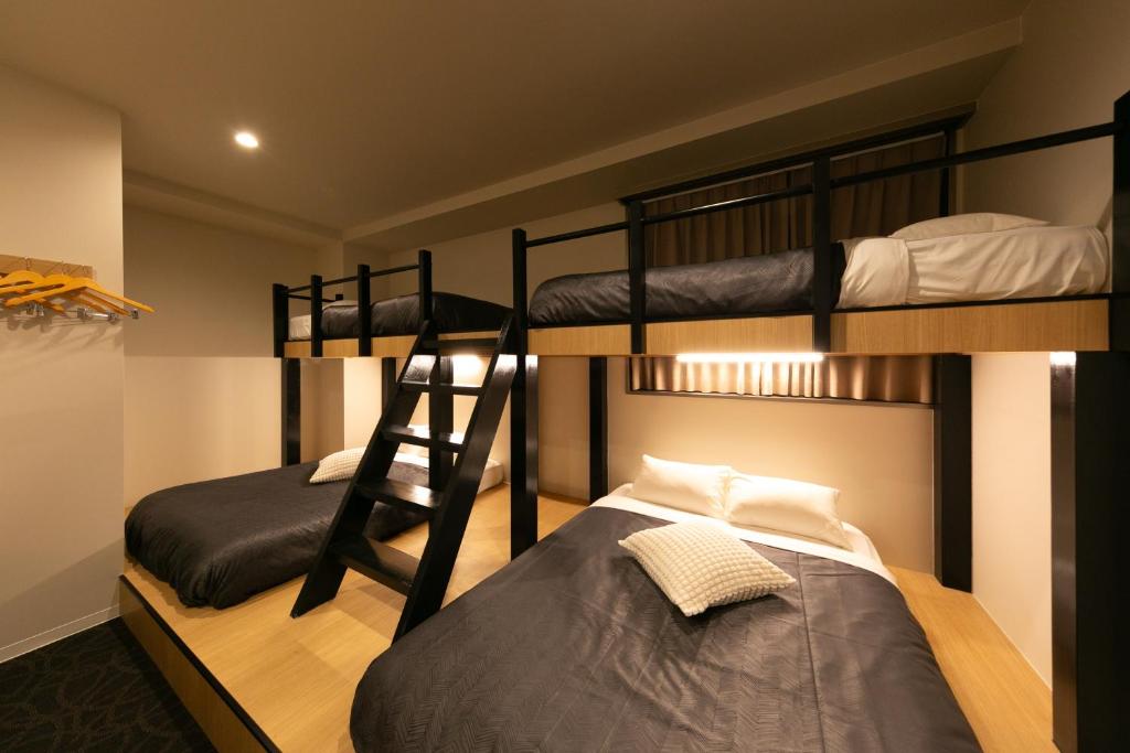 a bunk bed room with two bunk beds in it at Hotel Edge Nakasu in Fukuoka