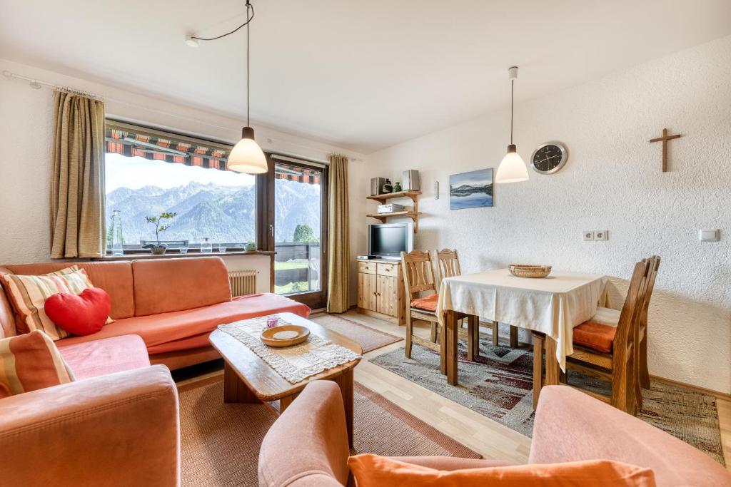 a living room with a couch and a table at Panorama Ferienwohnung Tschengla in Bürserberg