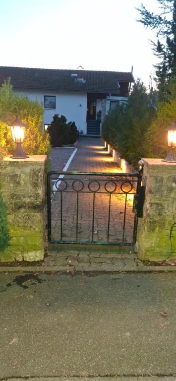 a gate in front of a house with a driveway at Hochwald appartement in Bad Sachsa