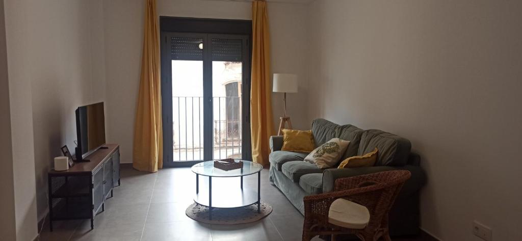a living room with a couch and a tv at Casa Carmen in Serón