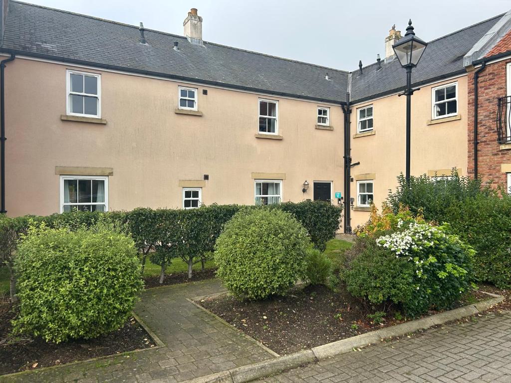 a house with bushes in front of it at Seaglass, The Bay - Filey Ground Floor Step Free Easy Access and Parking in Filey
