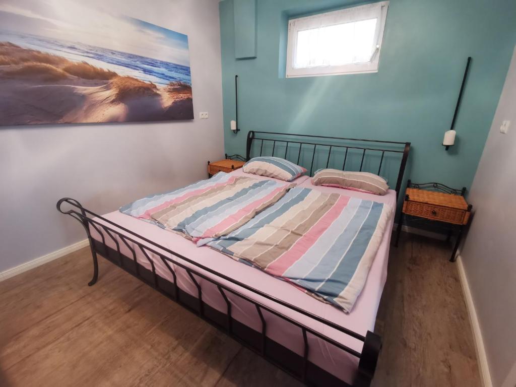 a bedroom with a bed with a striped comforter at Ferienwohnung Am Heimathof in Dorsten