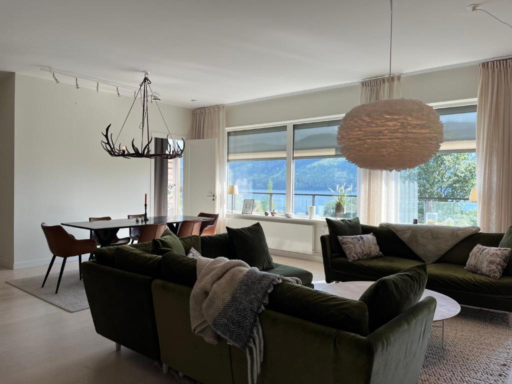 a living room with a couch and a dining room at Åre Stay - VM huset centralt i Åre in Åre