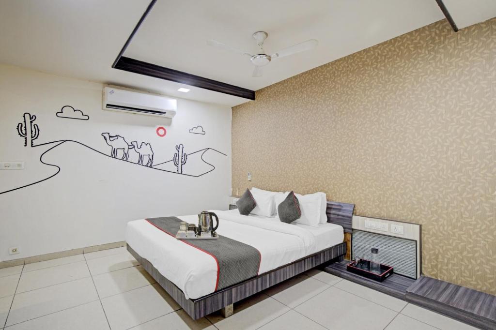 a bedroom with a bed and a drawing on the wall at Hotel Marina FREE Airport Drop in New Delhi