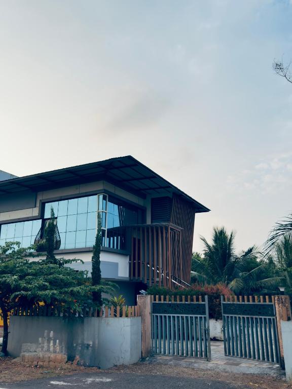 a house with a fence in front of it at E7 Apartment in Bekal