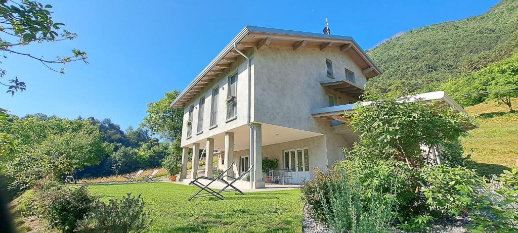 a large white house on a grassy field at Casa Meg in Tremosine Sul Garda