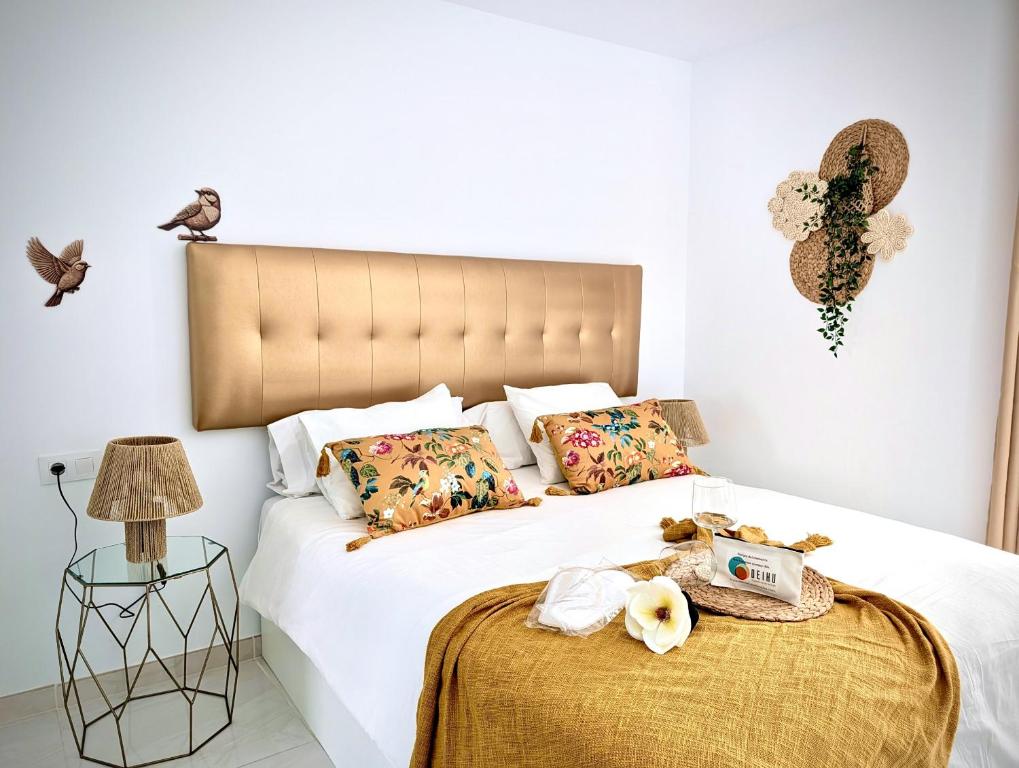 a bedroom with a large white bed with a large headboard at Luxury Bahia Sea Views by Deihu Experiences in Los Cristianos