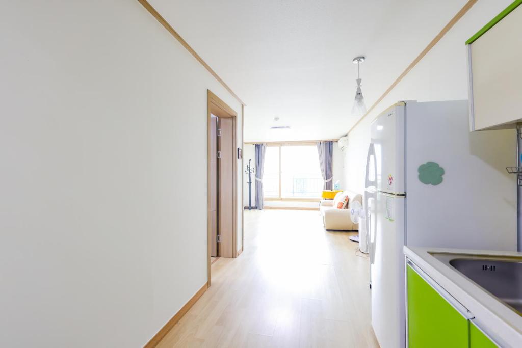 a kitchen with green and white cabinets and a counter at 온담펜션 