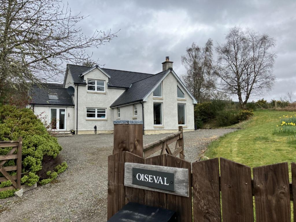 a house with a wooden fence in front of it at Oiseval in Fort Augustus