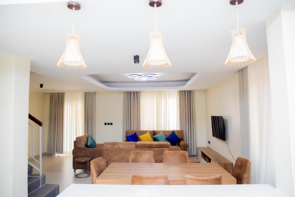 a living room with a couch and a table at A Beautiful home, Kanombe, Nyarugunga in Kigali