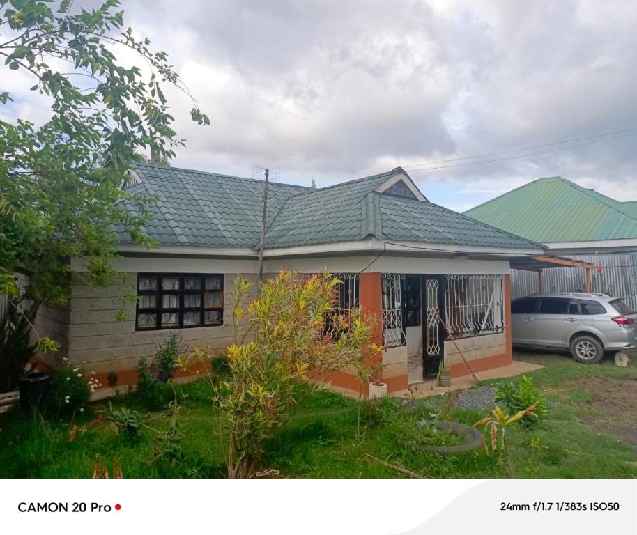 a house with a car parked in front of it at Hellena house in Nanyuki