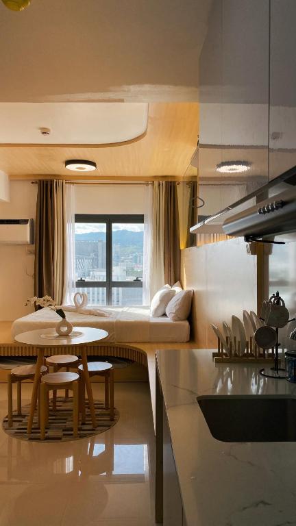 a kitchen and living room with a table and a couch at Cozy Nook at JTower Residences in Mandaue City