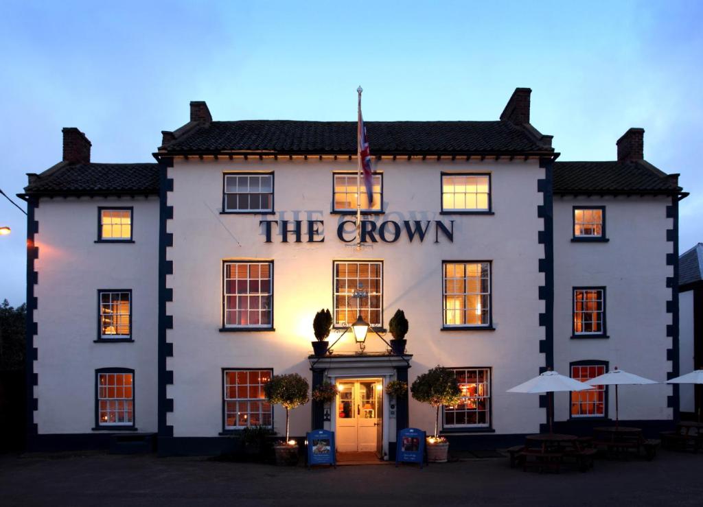 a large white building with a sign on it at The Crown Hotel in Wells next the Sea