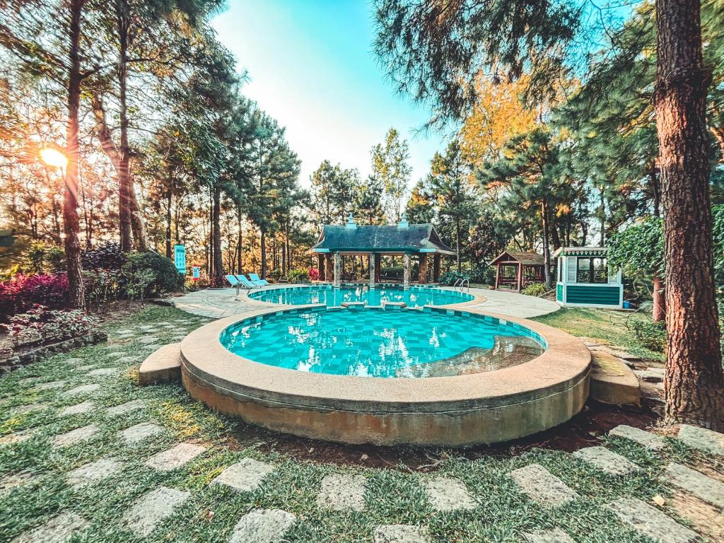 a swimming pool with a gazebo in a yard at Insta-Worthy Swiss House Crosswinds Tagaytay in Tagaytay