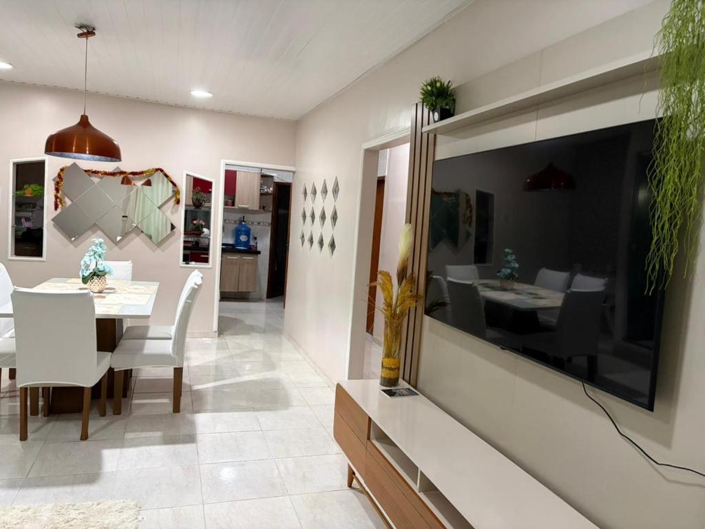 a dining room with a table and a large window at Grande casa para COP30 perto do parque da cidade in Belém